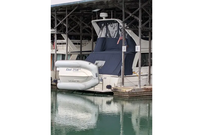 Slide: The Image of 1999 Bayliner 3988 Command Bridge Motoryacht docked with inflatable boat attached. - 98