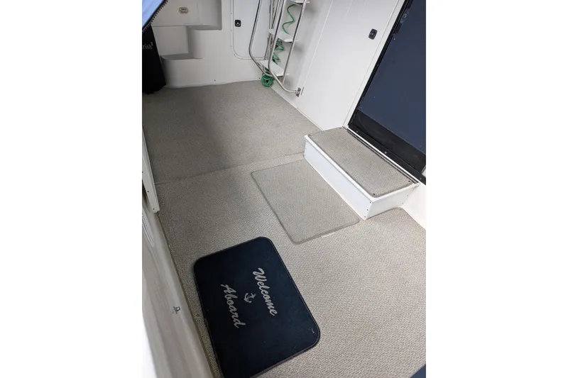 Slide: The Image of 1999 Bayliner 3988 Command Bridge Motoryacht interior with welcome mat and carpeted steps. - 99