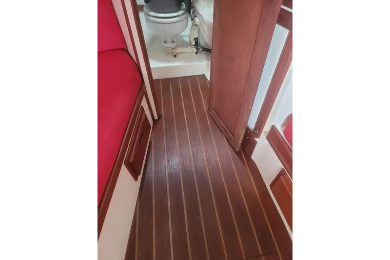 Slide: The Image of Interior of 1983 Atlantic City Kitty Kat 21 boat with wooden flooring and red seating. - 10