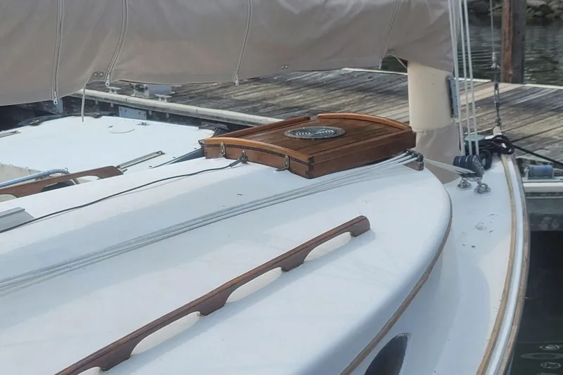 Slide: The Image of 1983 Atlantic City Kitty Kat 21 sailboat docked, featuring wooden accents and covered sails. - 7