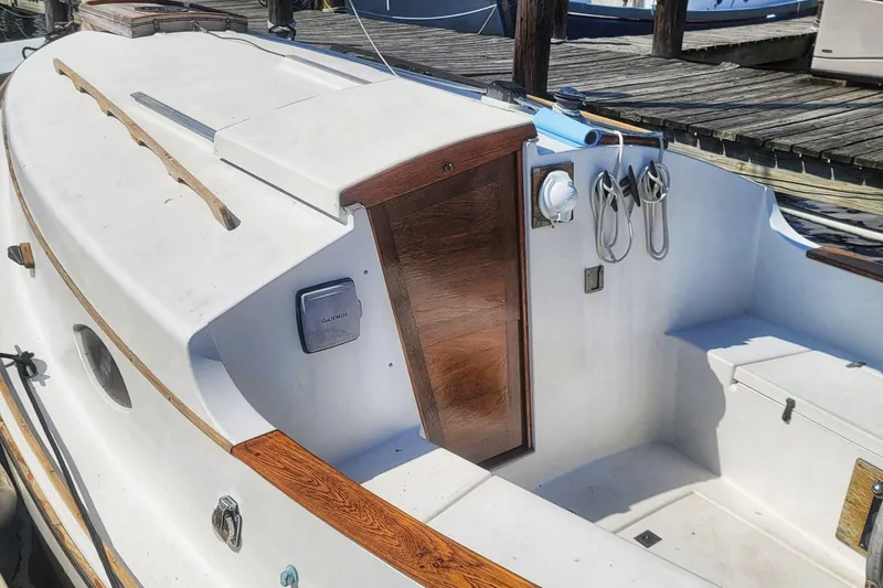 Slide: The Image of 1983 Atlantic City Kitty Kat 21 boat interior with wooden accents and docked at marina. - 8