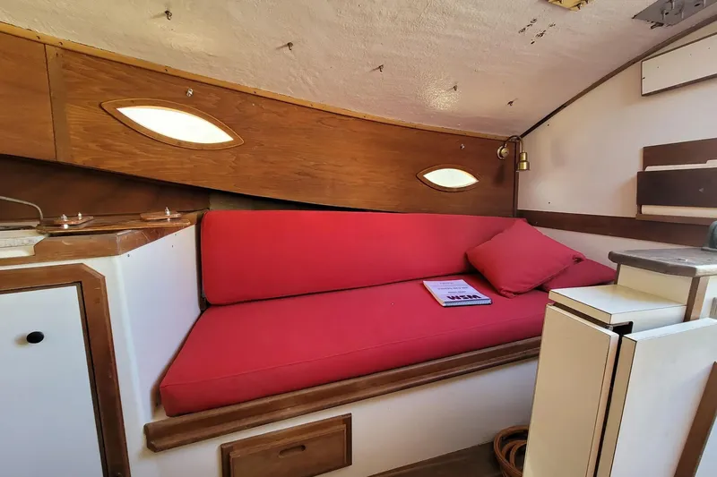 Slide: The Image of Interior of 1983 Atlantic City Kitty Kat 21 boat with red cushioned seating. - 9