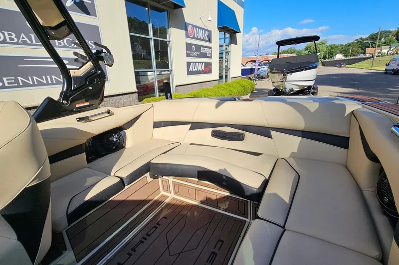Slide: The Image of Interior of a 2021 Centurion Fi21 boat with beige seating and modern design. - 10
