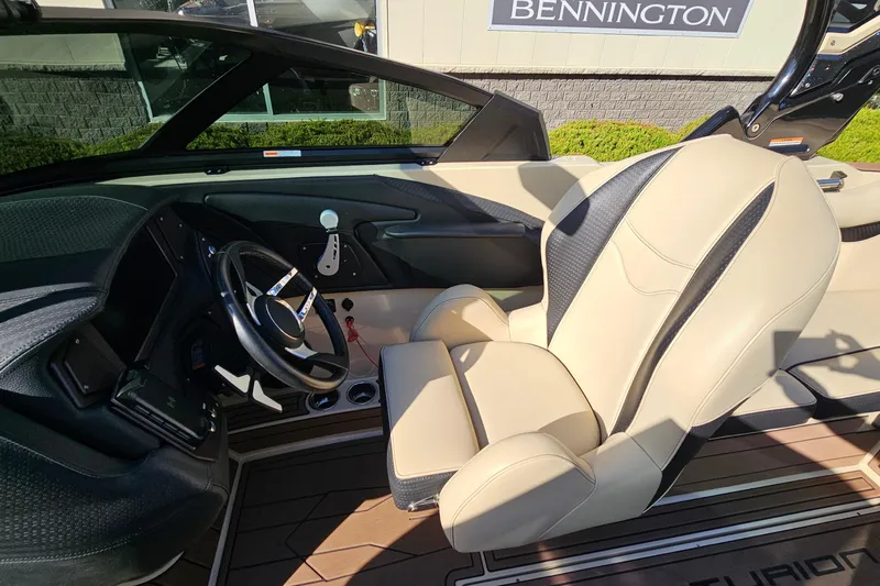 Slide: The Image of 2021 Centurion Fi21 boat interior with beige seating and modern steering wheel design. - 11