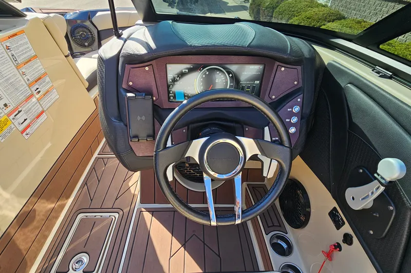 Slide: The Image of 2021 Centurion Fi21 boat dashboard with steering wheel and control panel. - 12