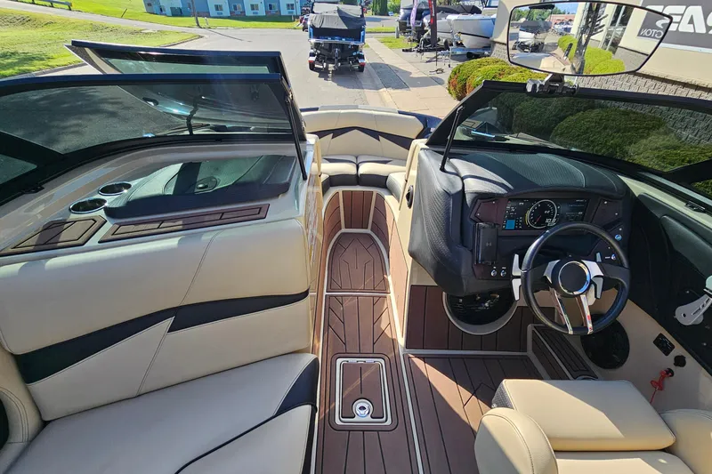 Slide: The Image of 2021 Centurion Fi21 boat interior with luxurious seating and modern dashboard design. - 13