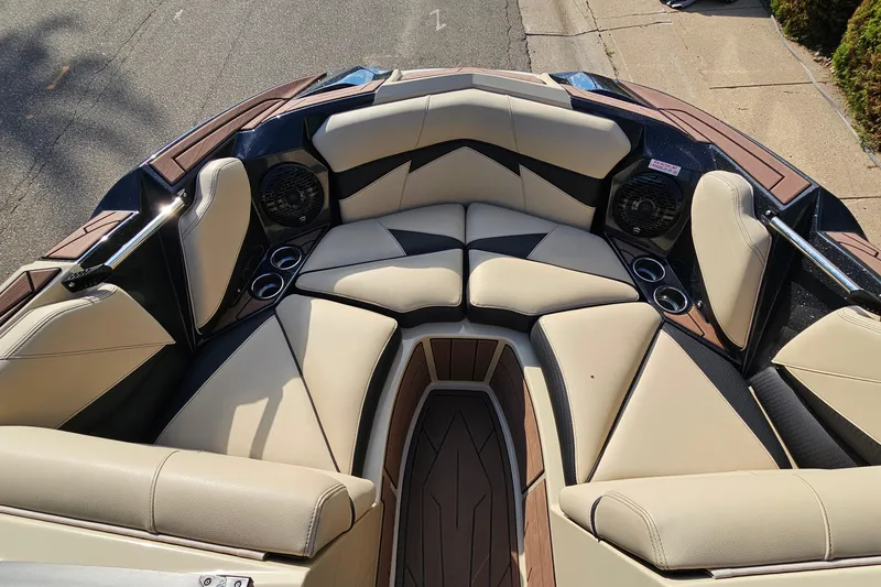 Slide: The Image of 2021 Centurion Fi21 boat interior with beige seating and cup holders. - 14