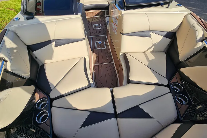 Slide: The Image of 2021 Centurion Fi21 boat interior with beige seating and wood accents. - 15