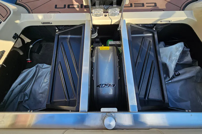 Slide: The Image of 2021 Centurion Fi21 boat engine compartment with storage trays and visible components. - 18