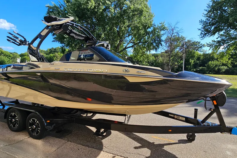 Slide: The Image of 2021 Centurion Fi21 boat on trailer, parked outdoors with trees in background. - 3