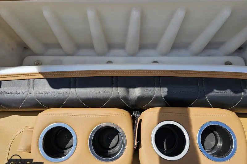 Slide: The Image of 2021 Regency 230 LE3 boat interior with cup holders and cushioned seating. - 100