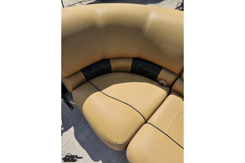 Slide: The Image of Tan leather seating on 2021 Regency 230 LE3 boat, featuring black accents and stitching. - 101