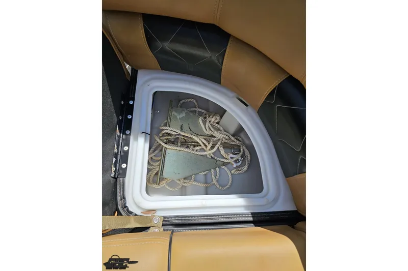 Slide: The Image of Storage compartment in 2021 Regency 230 LE3 boat with anchor and rope. - 102