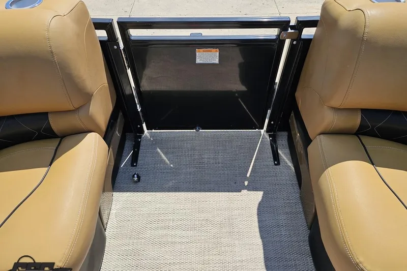 Slide: The Image of 2021 Regency 230 LE3 boat interior with tan seats and carpeted floor. - 109