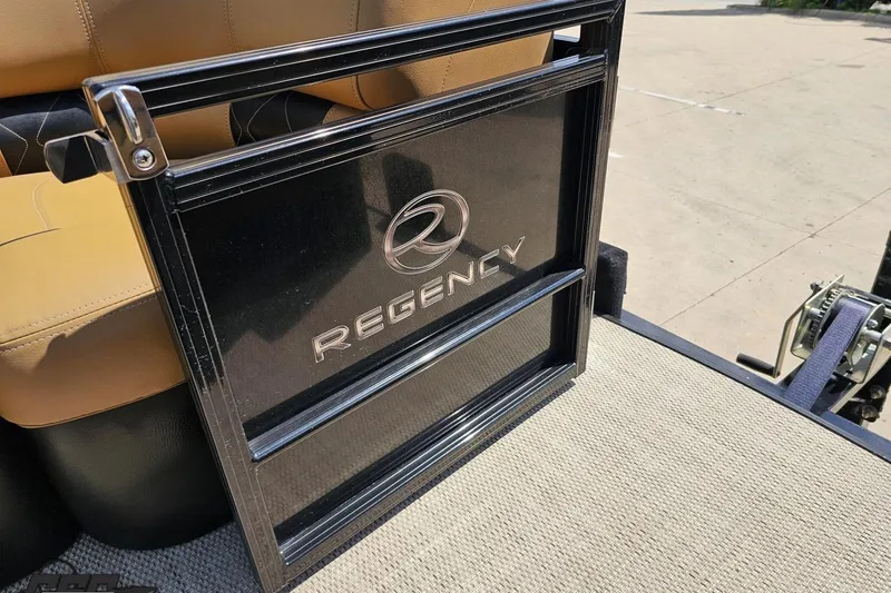 Slide: The Image of 2021 Regency 230 LE3 boat interior with branded panel and tan seating. - 110