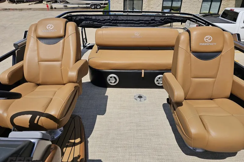 Slide: The Image of Luxurious seating on 2021 Regency 230 LE3 boat, featuring tan leather upholstery. - 114