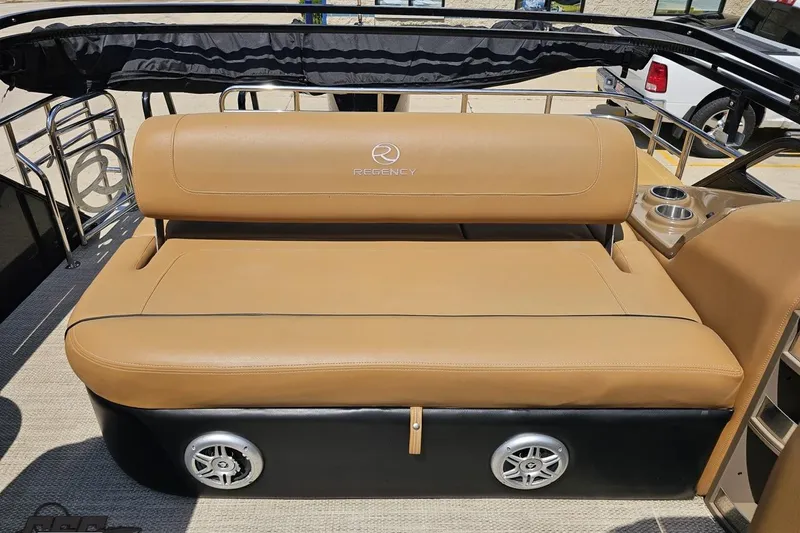 Slide: The Image of Tan seating on 2021 Regency 230 LE3 boat with cup holders and speakers. - 117