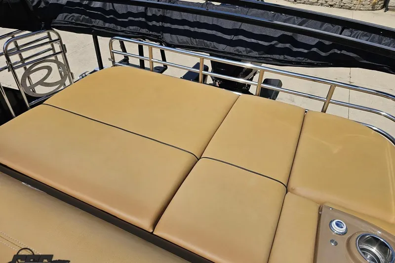 Slide: The Image of 2021 Regency 230 LE3 boat with tan cushioned seating and stainless steel railings. - 121