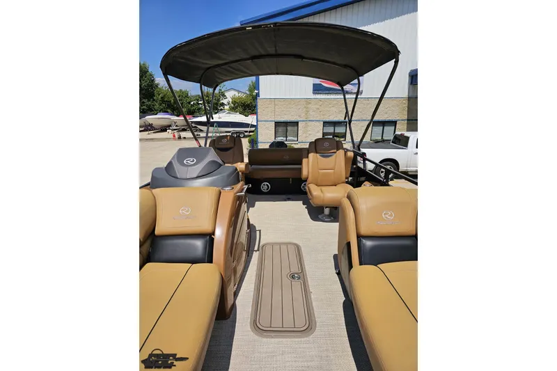 Slide: The Image of 2021 Regency 230 LE3 pontoon boat interior with tan seating and canopy. - 123