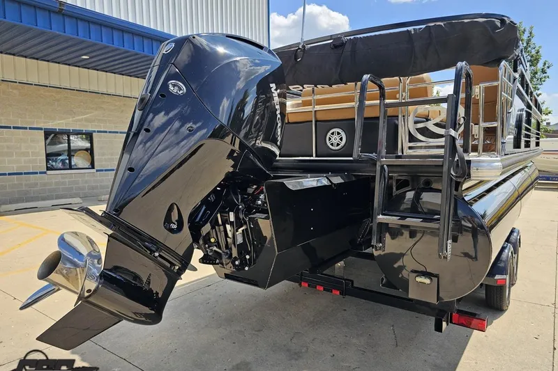 Slide: The Image of 2021 Regency 230 LE3 pontoon boat with powerful outboard motor, parked outdoors. - 16