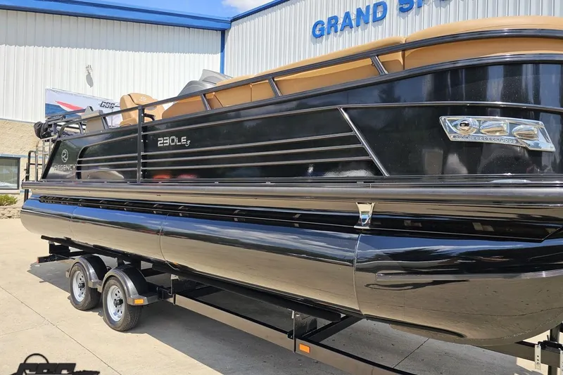 Slide: The Image of 2021 Regency 230 LE3 pontoon boat on trailer outside dealership. - 19