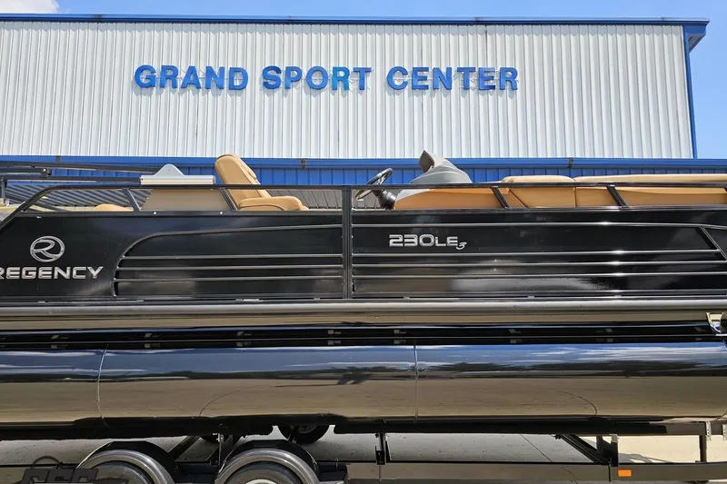 Slide: The Image of 2021 Regency 230 LE3 pontoon boat at Grand Sport Center dealership. - 3