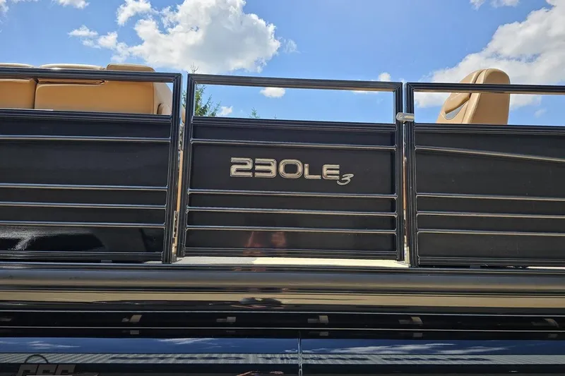 Slide: The Image of 2021 Regency 230 LE3 boat railing under blue sky with clouds. - 32