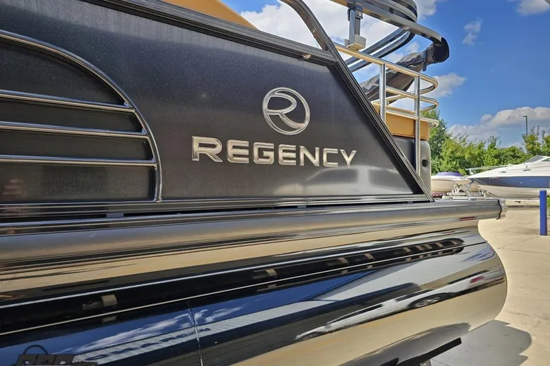 Slide: The Image of 2021 Regency 230 LE3 pontoon boat, sleek design, outdoor setting, blue sky background. - 34