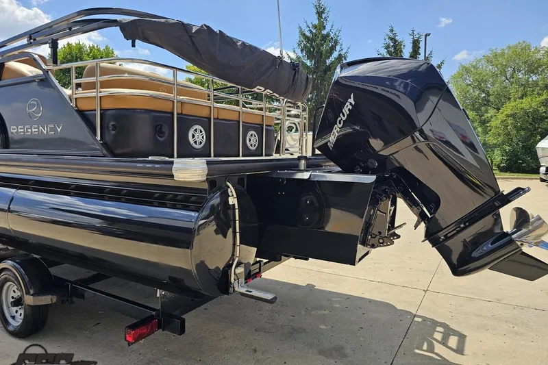 Slide: The Image of 2021 Regency 230 LE3 pontoon boat with Mercury outboard motor on trailer. - 40