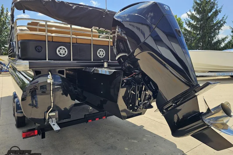 Slide: The Image of 2021 Regency 230 LE3 pontoon boat with powerful outboard motor on trailer. - 42