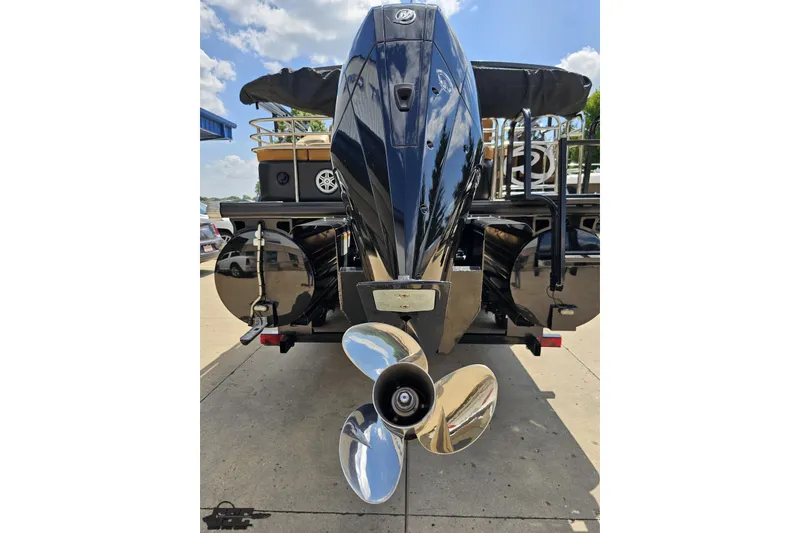 Slide: The Image of Rear view of 2021 Regency 230 LE3 boat with shiny propeller and blue sky. - 44
