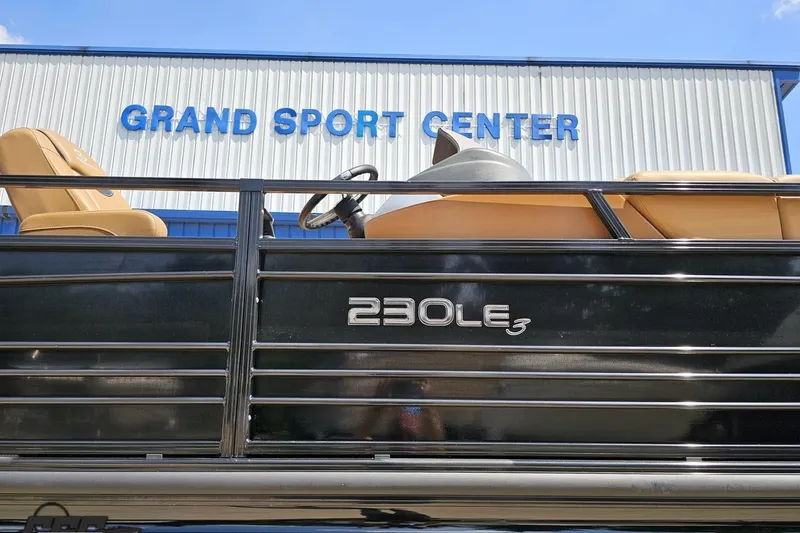 Slide: The Image of 2021 Regency 230 LE3 boat at Grand Sport Center, showcasing sleek design and luxury seating. - 5