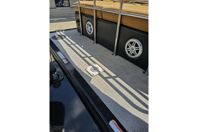 Slide: The Image of 2021 Regency 230 LE3 boat deck with speakers and railing in sunlight. - 52