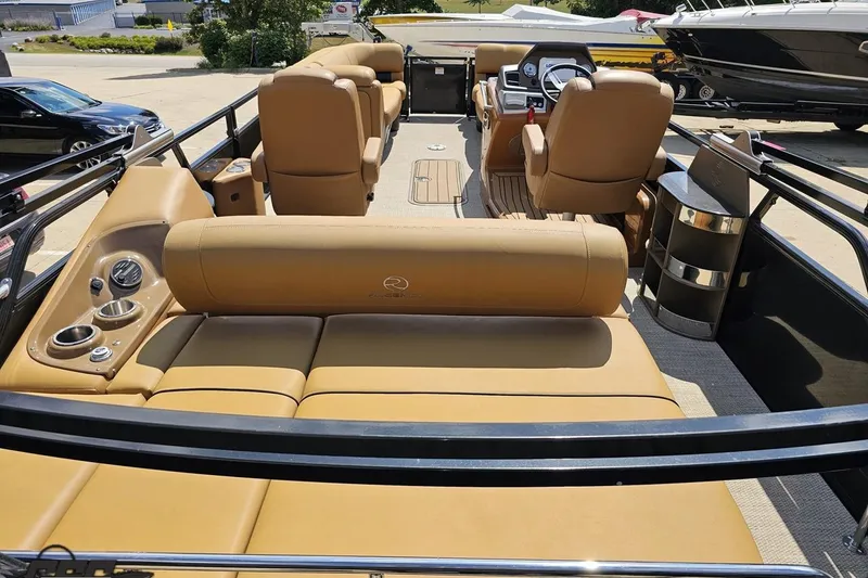 Slide: The Image of 2021 Regency 230 LE3 pontoon boat interior with tan seating and modern dashboard. - 53