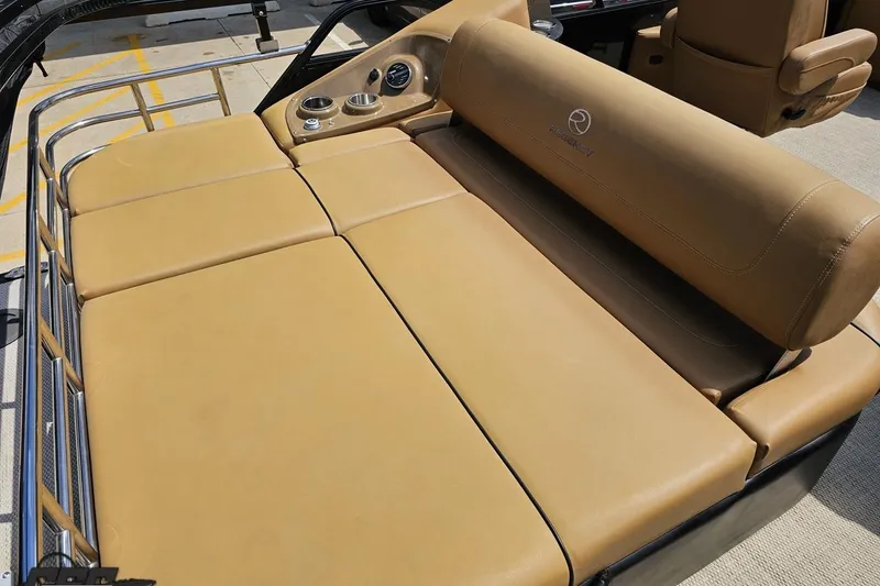 Slide: The Image of 2021 Regency 230 LE3 boat with tan leather seating and cup holders. - 56