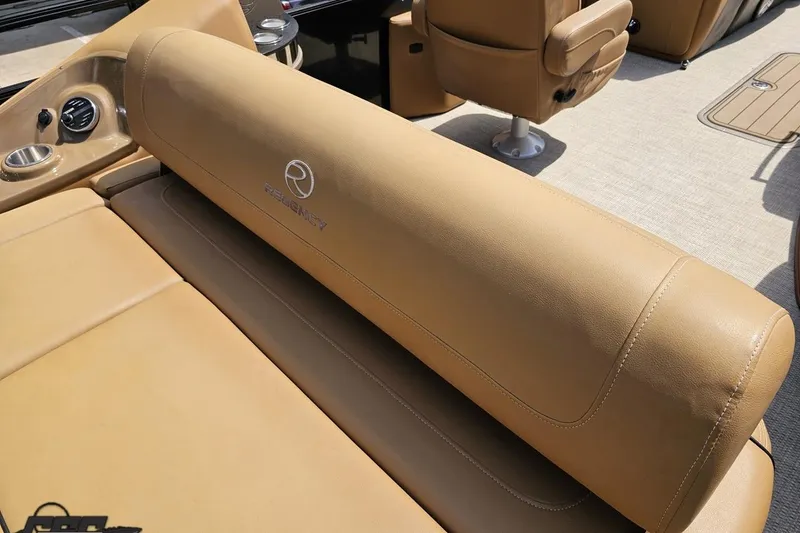 Slide: The Image of 2021 Regency 230 LE3 boat interior with tan leather seating and console details. - 58