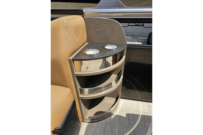 Slide: The Image of 2021 Regency 230 LE3 boat interior with cup holders and storage shelves. - 65