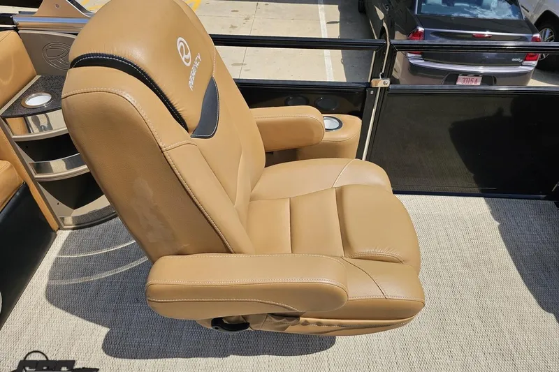 Slide: The Image of Tan captain's chair on 2021 Regency 230 LE3 boat, featuring cup holders and sleek design. - 67