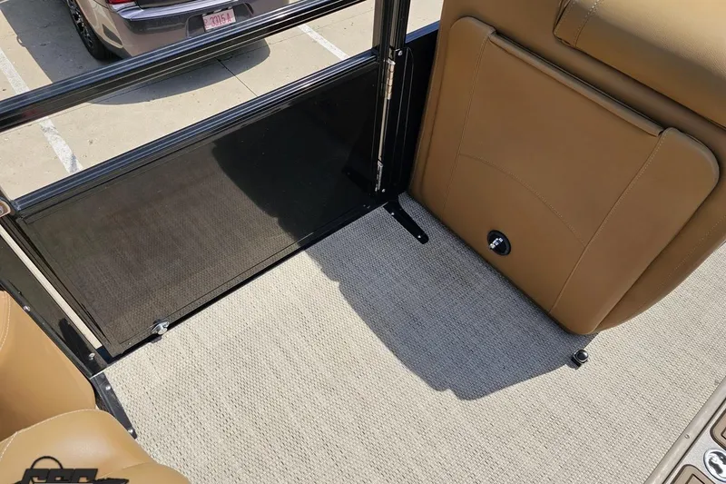 Slide: The Image of Interior of 2021 Regency 230 LE3 boat with tan seating and carpeted flooring. - 68