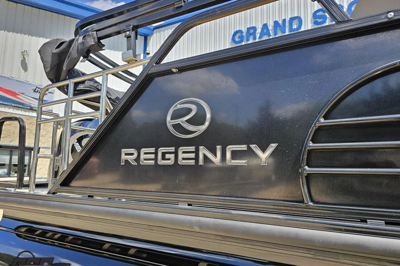 Slide: The Image of 2021 Regency 230 LE3 boat with logo, displayed outdoors. - 7