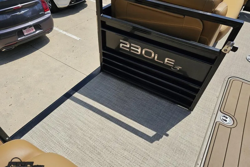 Slide: The Image of 2021 Regency 230 LE3 boat interior with tan seating and model branding. - 70