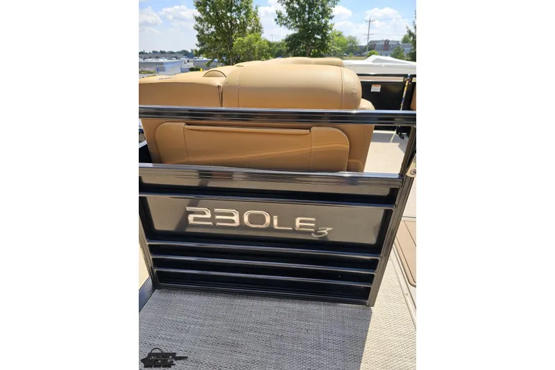 Slide: The Image of 2021 Regency 230 LE3 boat interior with tan seating and sleek black railing. - 71