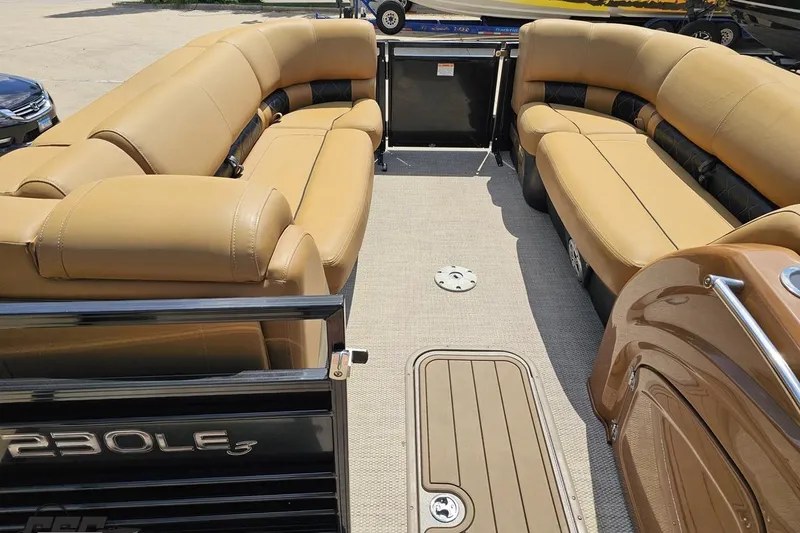 Slide: The Image of 2021 Regency 230 LE3 pontoon boat interior with tan seating and spacious layout. - 72