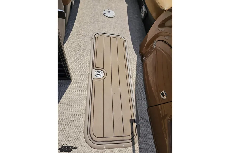 Slide: The Image of 2021 Regency 230 LE3 boat deck with storage compartment and textured flooring. - 73
