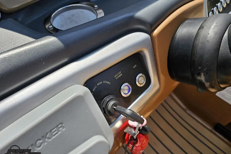 Slide: The Image of Dashboard controls of a 2021 Regency 230 LE3 boat with ignition key and buttons. - 80