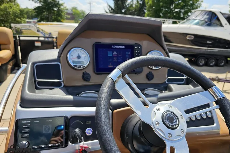 Slide: The Image of Steering wheel and dashboard of 2021 Regency 230 LE3 boat with navigation system. - 81