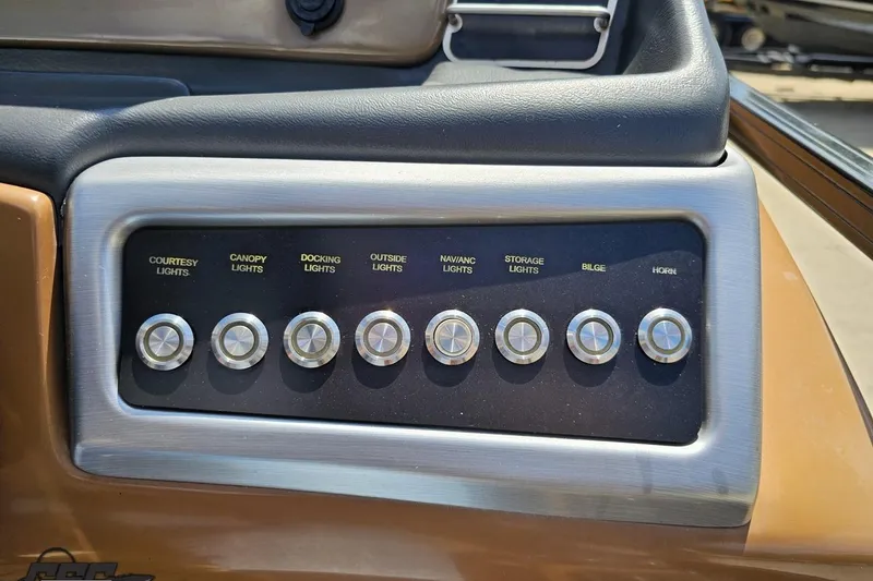 Slide: The Image of Control panel of a 2021 Regency 230 LE3 boat with labeled switches. - 87