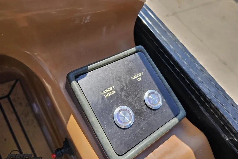 Slide: The Image of Control panel of 2021 Regency 230 LE3 boat with canopy up and down buttons. - 88