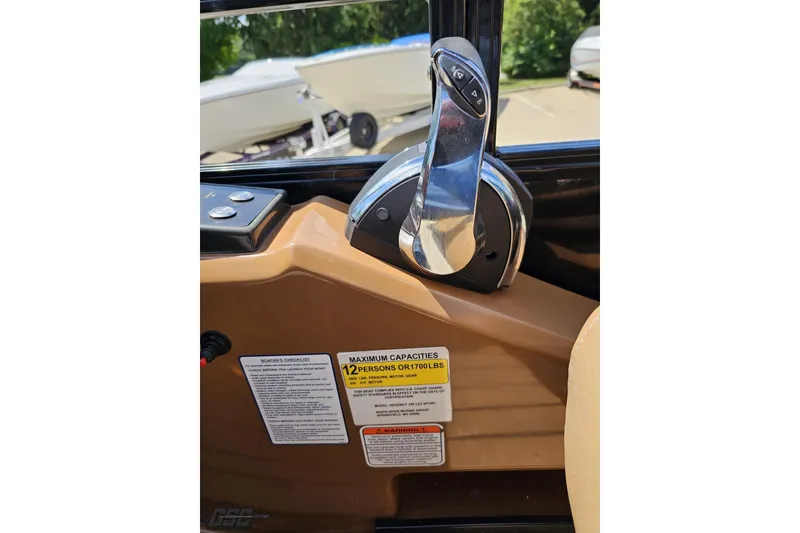Slide: The Image of Throttle control of 2021 Regency 230 LE3 boat with capacity label for 12 persons. - 89