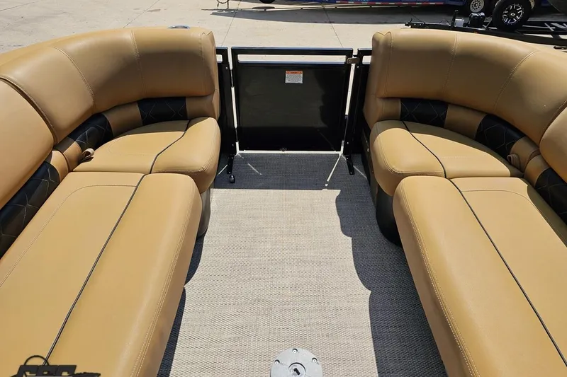 Slide: The Image of 2021 Regency 230 LE3 boat interior with tan leather seating and black accents. - 91